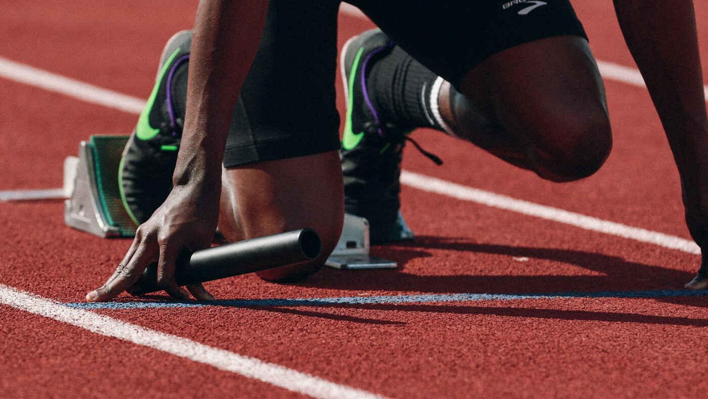 A runner training outdoors, the kind of athletic performance SoftWave therapy supports