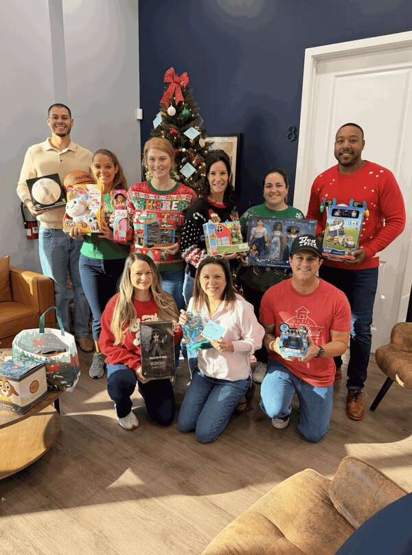 The team with gifts gathered for the Angel Giving Tree