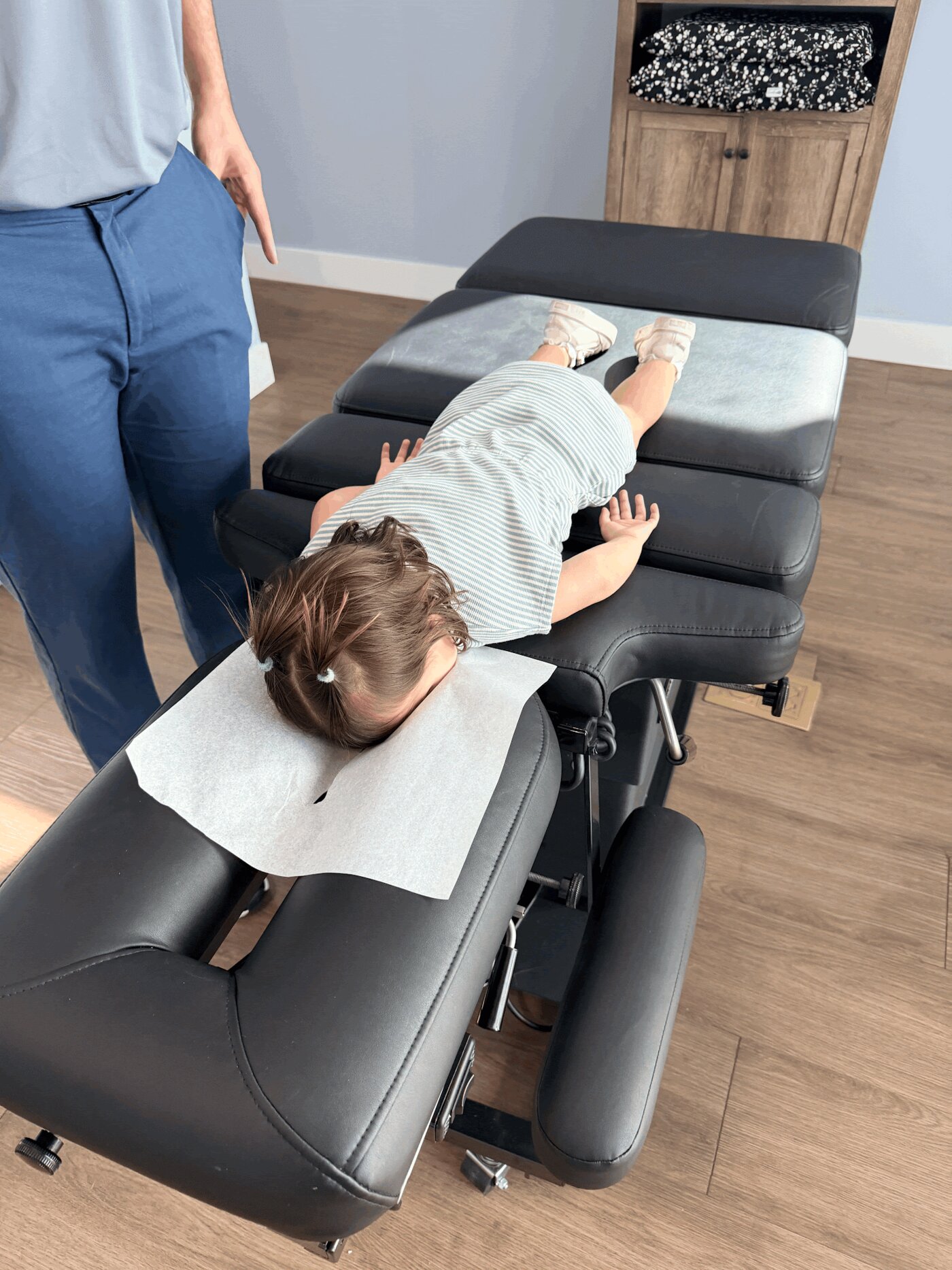 A child receiving a gentle chiropractic adjustment at Experience Health & Wellness Center